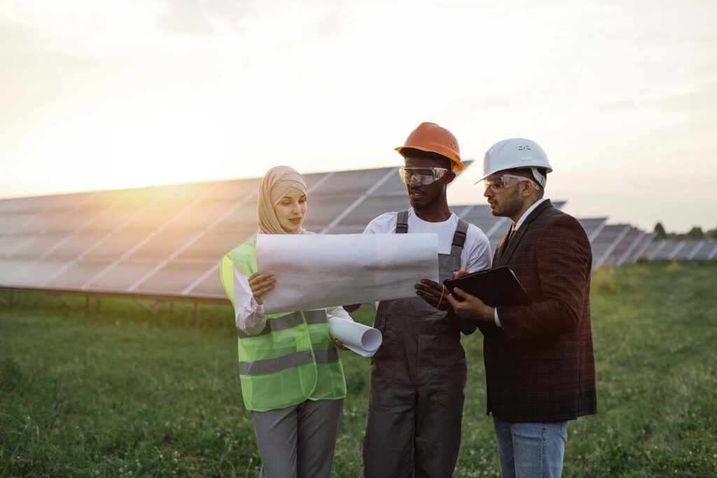 multi-ethnic-people-discussing-work-at-solar-stati-HFXPKUV.jpg